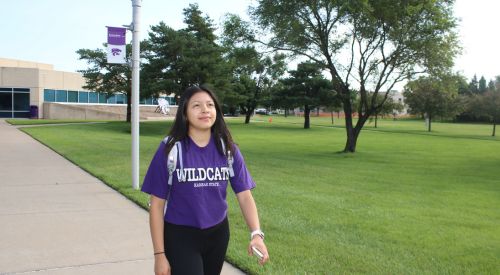 High school students can take college classes through K-State Salina while still in high school as student walks to class on campus.